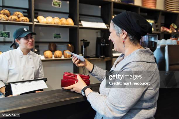 customer service in a small local bakery shop. - paying bill stock pictures, royalty-free photos & images