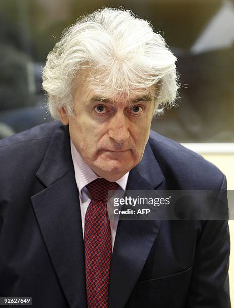 Former Bosnian Serb leader Radovan Karadzic looks up during his first court appearance since the start of his genocide trial in the courtroom of the...