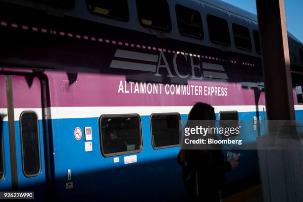 Commuter stands near a San Joaquin Regional Rail Commission Altamont Commuter Express train on a platform at the San Jose Diridon train station in...