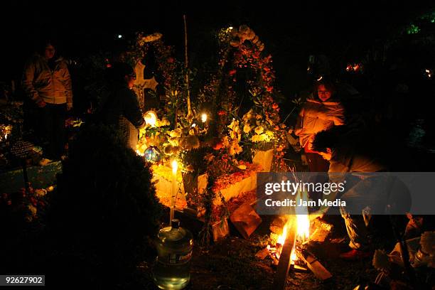 Faithful celebrate the Dia de los Muertos' at the Xilotepec cemetery on November 2, 2009 in Xochimilco, Mexico. Once a year, the Xilotepec cemetery...