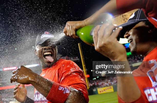 Ryan Howard of the Philadelphia Phillies is sprayed down with champagne by teammate Pedro Martinez as they celebrate defeating the Los Angeles...