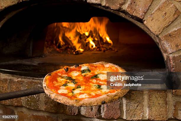 pizza and brick oven - stone material stock pictures, royalty-free photos & images