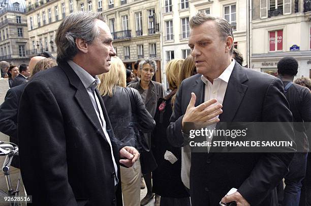 French singer Philippe Lavil and French fashion designer Jean-Charles de Castelbajac talk before attending a mass, at the Saint-Roch church in Paris,...