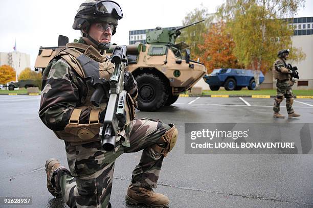 French military officer poses with an assault rifle and an bullet proof vest at the French gendarmerie headquarters in Satory, southwestern suburb of...