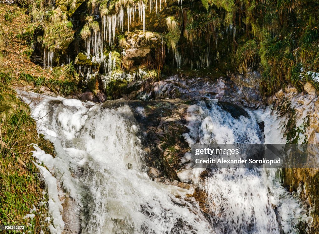 Beautiful high waterfall in Black Forest mountains, winter, snow and ice, Germany