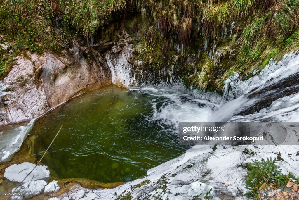 Beautiful high waterfall in Black Forest mountains, winter, snow and ice, Germany