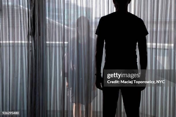 man and woman facing each other on balkony. - violenza donne foto e immagini stock