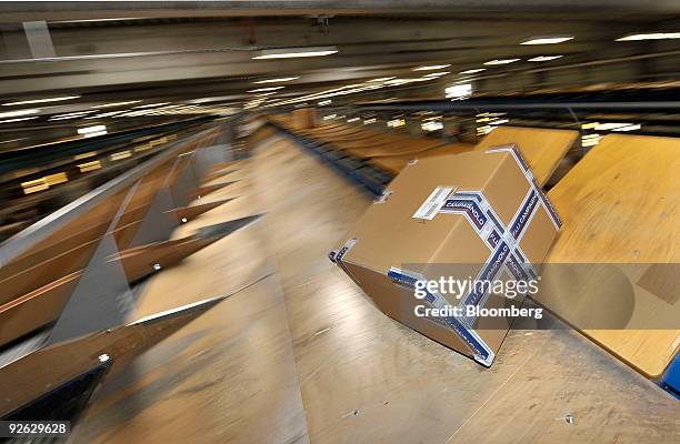 Parcel is processed through a sorting machine at a Deutsche Post AG package sorting center in Aschheim, near Munich, Germany on Tuesday, Nov. 3,...