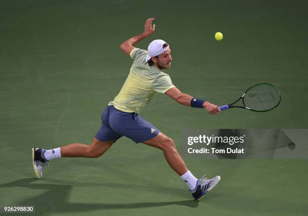 Lucas Pouille of France plays a backhand during his semi final match against Filip Krajinovic of Serbia on day five of the ATP Dubai Duty Free Tennis...