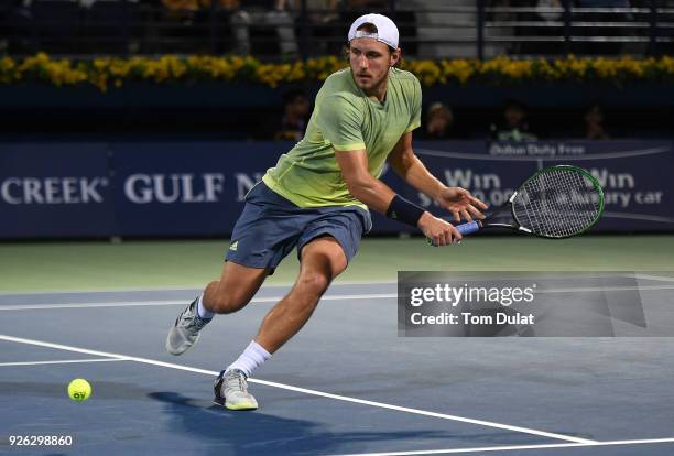 Lucas Pouille of France returns a shot during his semi final match against Filip Krajinovic of Serbia on day five of the ATP Dubai Duty Free Tennis...