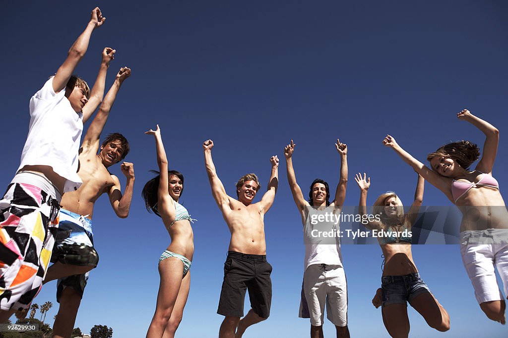 Group of friends jumping into the air