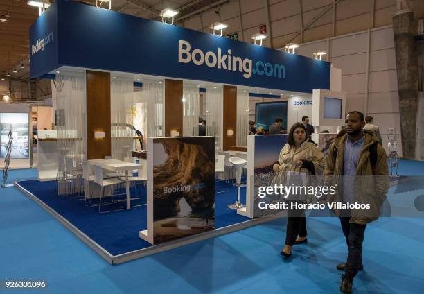 Visitors walk by "Booking.com" stand at BTL "Bolsa de Turismo Lisboa" trade fair on March 02, 2018 in Lisbon, Portugal. BTL is the benchmark for the...