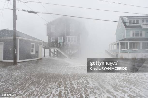Coastal areas in New England are bracing for the high tide that is scheduled to be at it's highest as waves crash into homes in Scituate,...