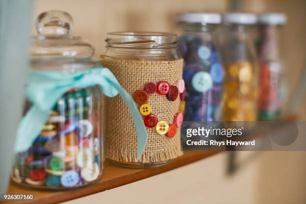 decorative jar on shelf - bottone articoli di merceria foto e immagini stock