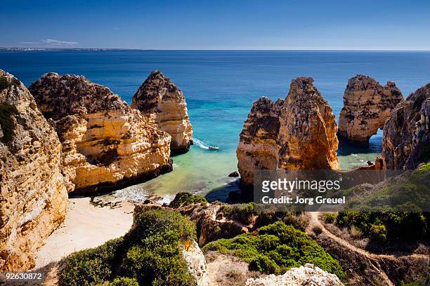 rocky coastline near ponta da piedade - ponta da piedade stock pictures, royalty-free photos & images