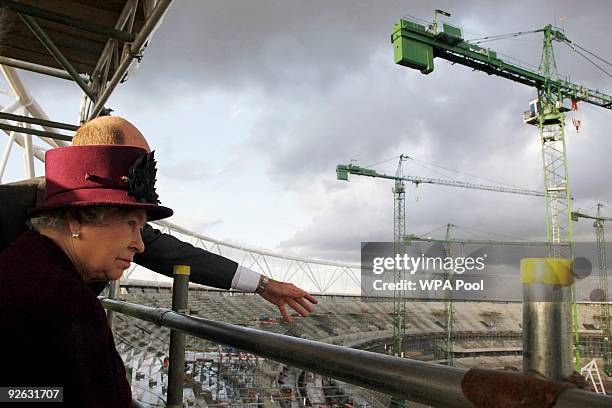 Britain's Queen Elizabeth II views the main Olympic stadium construction site during her visit to the London 2012 Olympic Park site in Stratford on...