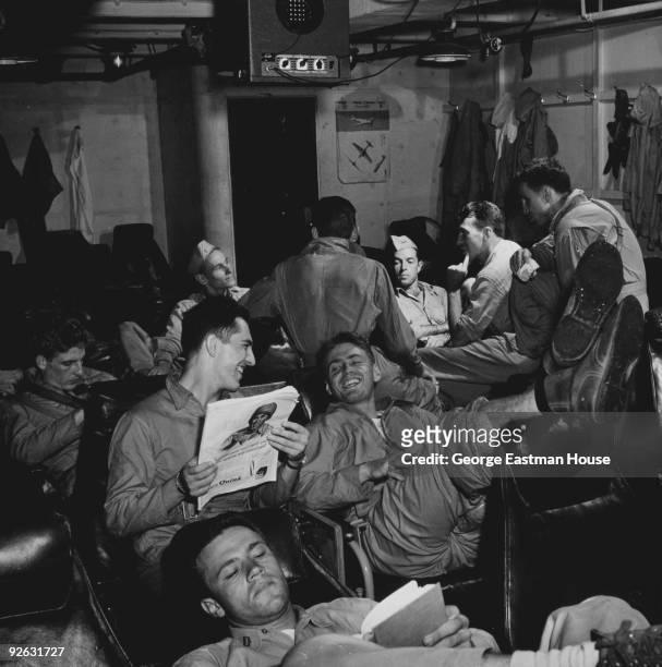 Group of sailors enjoy a little bit of rest and relaxation while on a US Navy ship during the war in the Pacific, ca.1944.