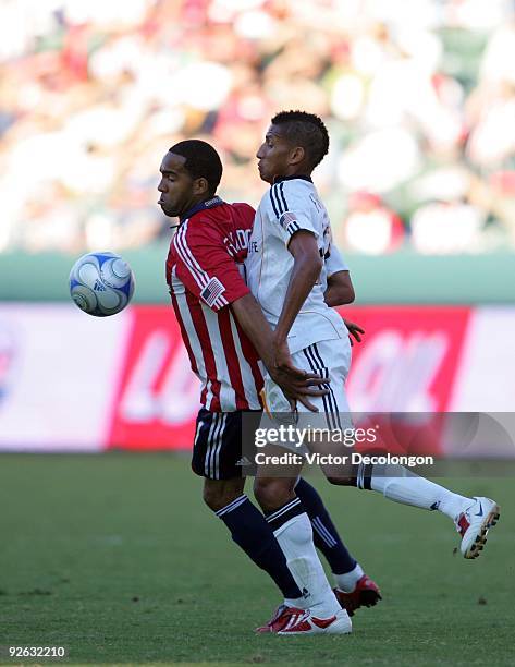 Maykel Galindo of Chivas USA protects the ball from Sean Franklin of the Los Angeles Galaxy during Game 1 of the MLS Western Conference Semifinals...