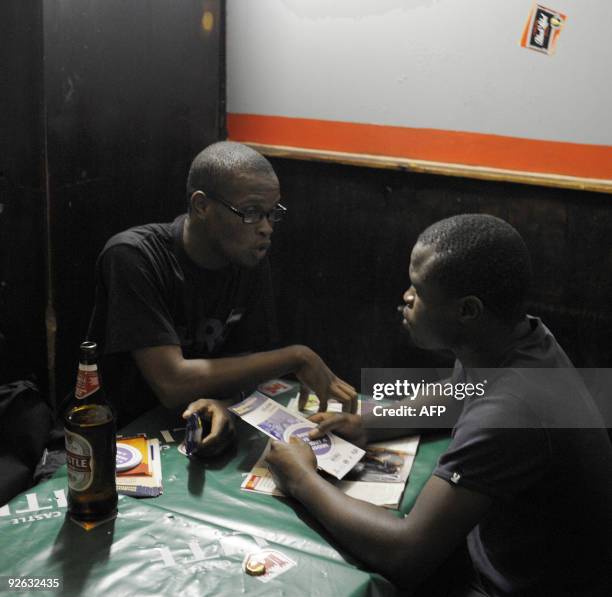 Recent picture on a peer educator from the Reproductive Health Research Unit giving out condoms and leaflets as a talks to a man in a bar around...