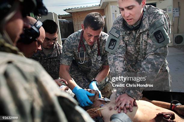 Military doctors attend to a grievously wounded unidentified Afghan National Army soldier at Kandahar Air Field's trauma center November 1, 2009 in...