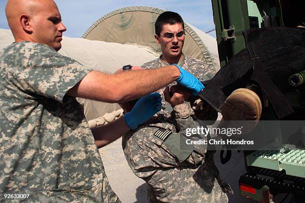 Medics pull out the guerney carrying a grievously wounded unidentified Afghan National Army soldier at Kandahar Air Field's trauma center November 1,...