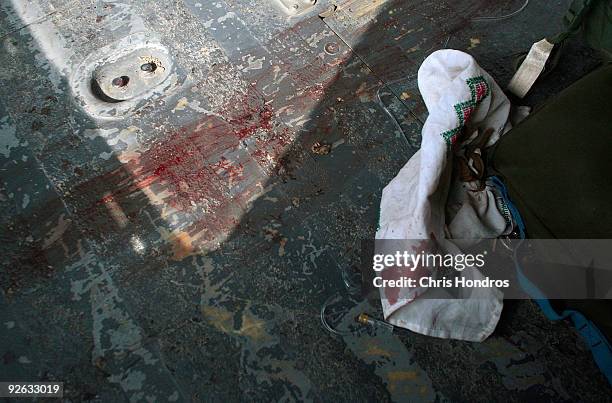 The scuffed and bloody metal floor of a Medivac helicopter with the 82nd Airborne Combat Aviation Brigade is seen after transporting a grievously...