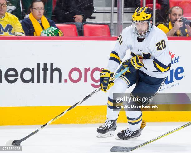 Cooper Marody of the Michigan Wolverines skates up ice with the puck against the Bowling Green Falcons during game two of the Great Lakes...