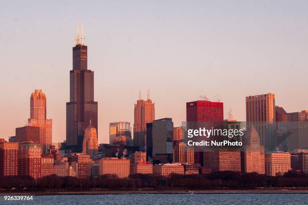 Views of the sun rising to illuminate the Chicago skyline from the Adler Planetarium on March 2, 2018.