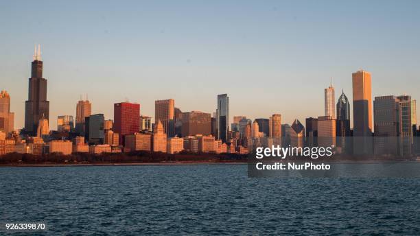 Views of the sun rising to illuminate the Chicago skyline from the Adler Planetarium on March 2, 2018.