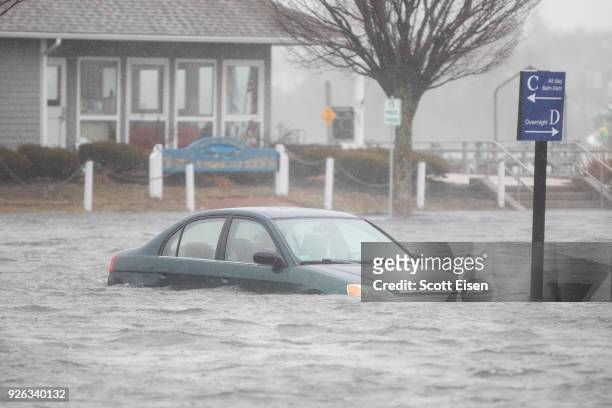 Flooded car parked in a lot behind Front St. As a large coastal storm affects the area on March 2, 2018 in Scituate, Massachusetts. A nor'easter is...