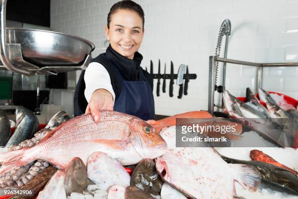 woman selling fish - fishmonger stock pictures, royalty-free photos & images