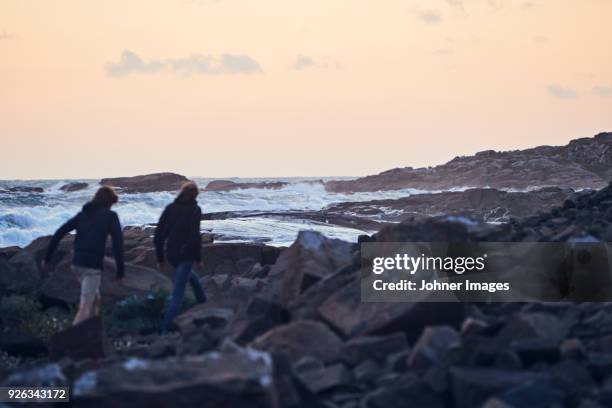 couple walking at sea - halland stock pictures, royalty-free photos & images