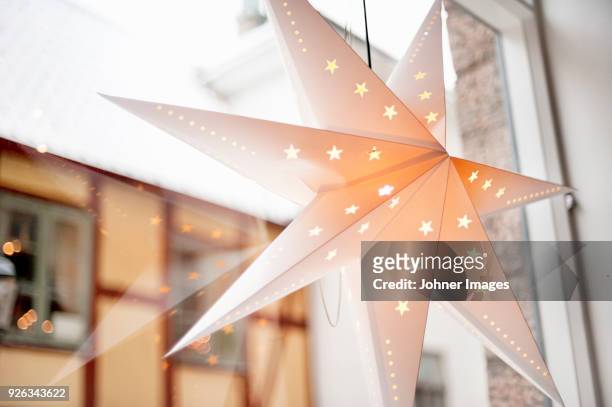 star hanging on window - national day in sweden 2017 stockfoto's en -beelden