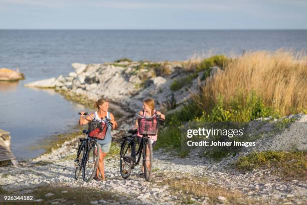 young women cycling on sea coast - gotland sweden stock pictures, royalty-free photos & images