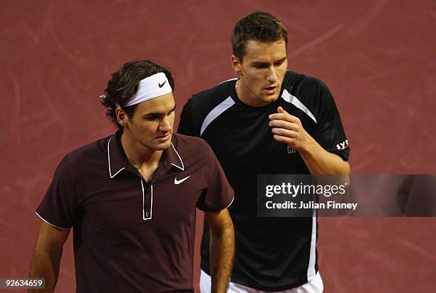 Roger Federer and Marco Chiudinelli of Switzerland look on in their match against James Cerretani of USA and Aisam-ul-Haq Qureshi of Pakistan in the...