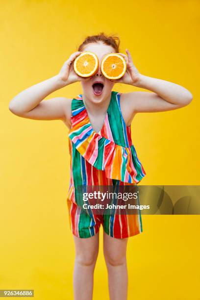 girl holding oranges - colorful fruit stock pictures, royalty-free photos & images