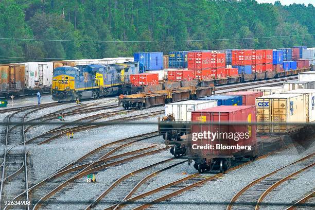 Locomotive and railcars sit in a railyard depot in Jacksonville, Florida, U.S., on Wednesday, Oct. 28, 2009. Warren Buffett's Berkshire Hathaway Inc....