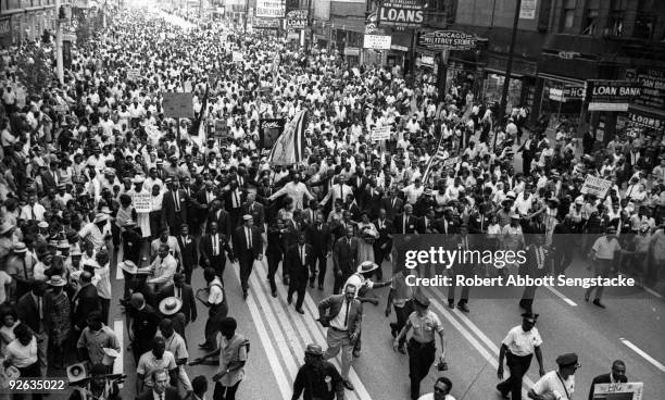 American clergyman and civil rights leader Dr. Martin Luther King Jr. Marches with hundreds of supporters and members of the Chicago Freedom Movement...