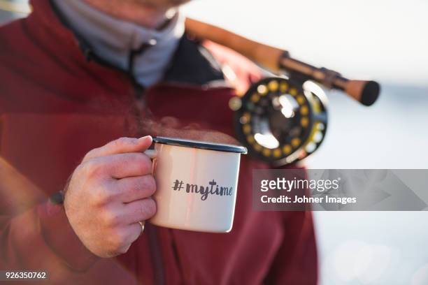 close-up of man holding mug - word cup ストックフォトと画像