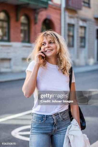 young woman on street talking via cell phone - göteborg stad bildbanksfoton och bilder