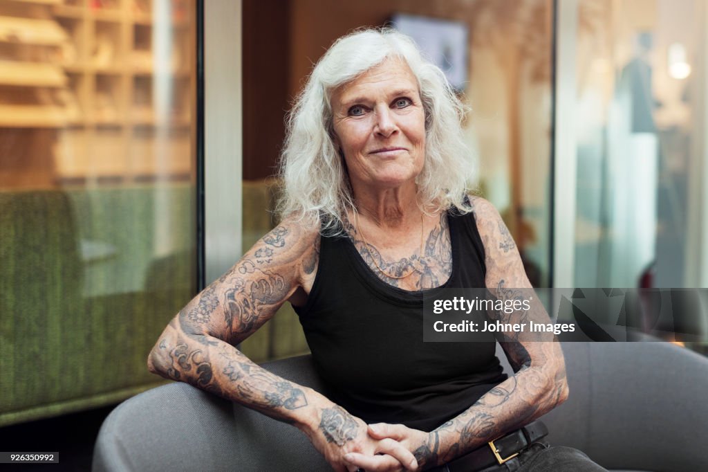 Portrait of senior woman with tattoos