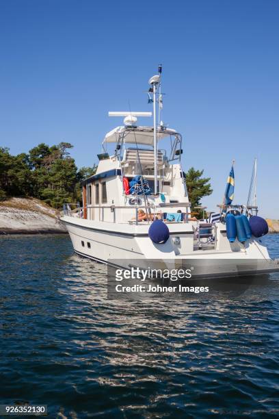 woman sunbathing on a boat - stockholm archipelago stock pictures, royalty-free photos & images