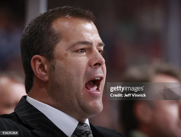 Head coach Alain Vigneault of the Vancouver Canucks looks on from the bench during their game against the Detroit Red Wings at General Motors Place...