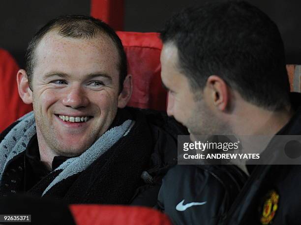 Manchester United's English forward Wayne Rooney laughs with fellow substitute Irish defender John O'Shea before their UEFA Champions League Group B...