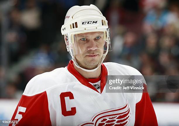 Nicklas Lidstrom of the Detroit Red Wings looks on from the bench during their game against the Vancouver Canucks at General Motors Place on October...