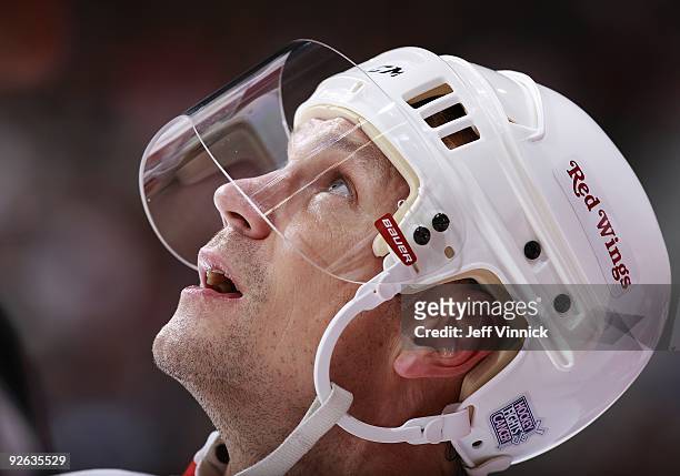 Nicklas Lidstrom of the Detroit Red Wings looks on from the bench during their game against the Vancouver Canucks at General Motors Place on October...