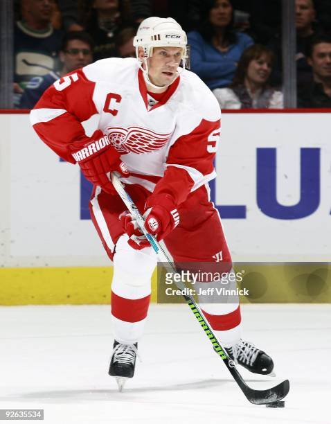 Nicklas Lidstrom of the Detroit Red Wings skates up ice with the puck during their game against the Vancouver Canucks at General Motors Place on...