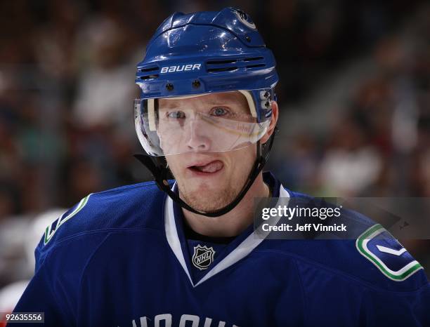 Christian Ehrhoff of the Vancouver Canucks looks on from the bench during their game against the Detroit Red Wings at General Motors Place on October...