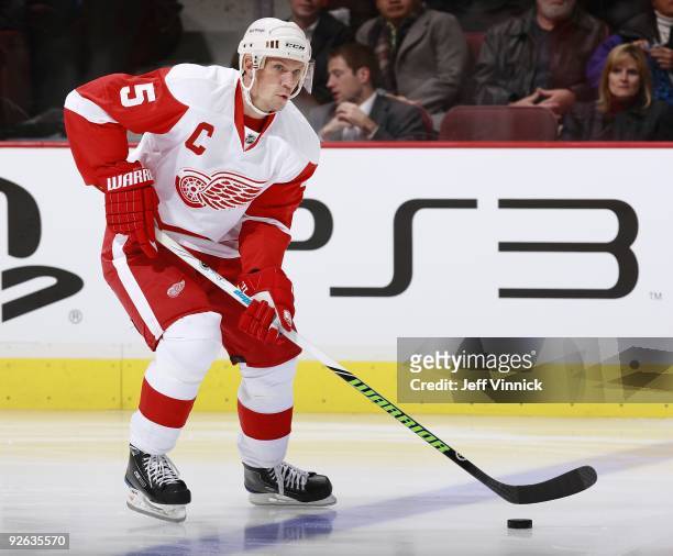 Nicklas Lidstrom of the Detroit Red Wings skates up ice with the puck during their game against the Vancouver Canucks at General Motors Place on...
