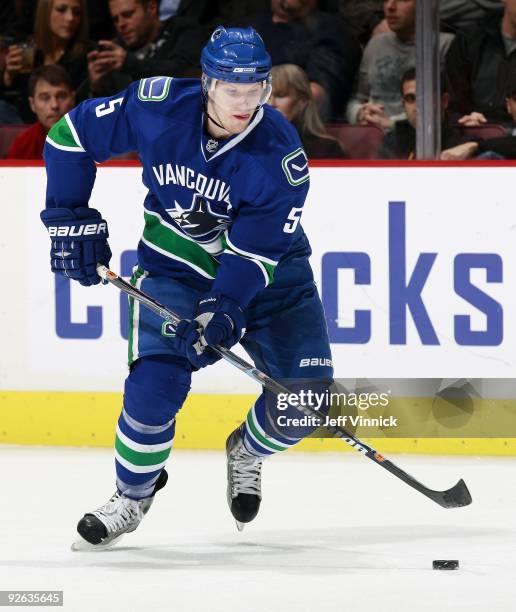 Christian Ehrhoff of the Vancouver Canucks skates up ice with the puck during their game against the Detroit Red Wings at General Motors Place on...